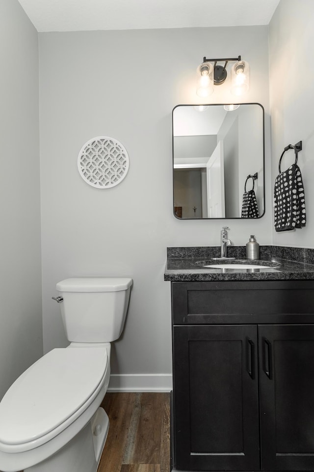 1261 Skyview Cir NW, Rochester, MN 55901 - half bathroom featuring toilet, wood finished floors, vanity, and baseboards