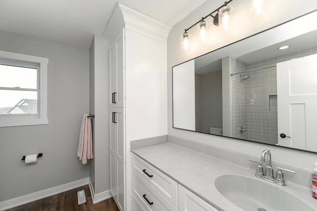 1261 Skyview Cir NW, Rochester, MN 55901 - bathroom featuring vanity, wood finished floors, a shower, baseboards, and toilet