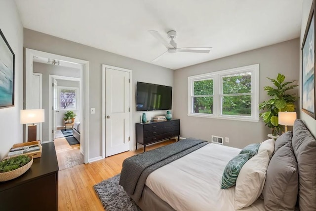 810 57th Ave N, Brooklyn Center, MN 55430 - bedroom with light wood-style flooring and ceiling fan