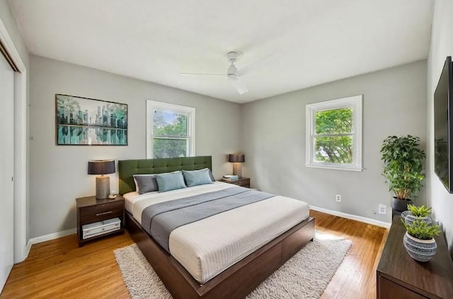 810 57th Ave N, Brooklyn Center, MN 55430 - bedroom featuring multiple windows, baseboards, and light wood-type flooring