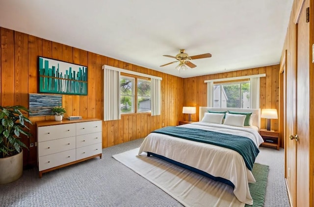 810 57th Ave N, Brooklyn Center, MN 55430 - bedroom featuring carpet floors, wooden walls, and a ceiling fan