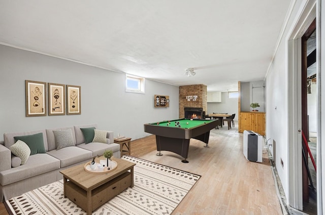 810 57th Ave N, Brooklyn Center, MN 55430 - rec room with light wood finished floors, billiards table, and a brick fireplace