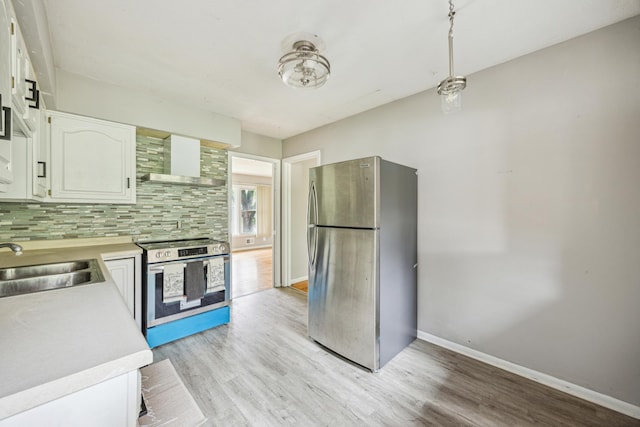 810 57th Ave N, Brooklyn Center, MN 55430 - kitchen featuring appliances with stainless steel finishes, wall chimney exhaust hood, light countertops, and a sink