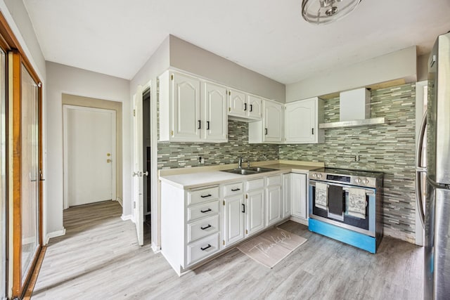 810 57th Ave N, Brooklyn Center, MN 55430 - kitchen featuring a sink, stainless steel appliances, wall chimney exhaust hood, light wood finished floors, and decorative backsplash