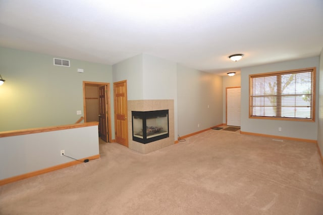 11096 16th St NE, Saint Michael, MN 55376 - unfurnished living room featuring a tiled fireplace, light colored carpet, and baseboards