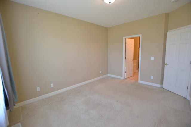 11096 16th St NE, Saint Michael, MN 55376 - unfurnished bedroom with light colored carpet, baseboards, and ensuite bathroom