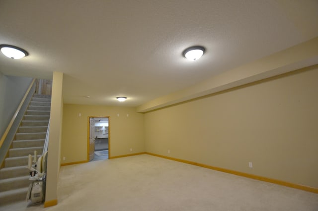 11096 16th St NE, Saint Michael, MN 55376 - finished below grade area with stairway, carpet floors, baseboards, and a textured ceiling