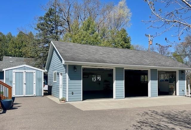 detached garage featuring a storage unit