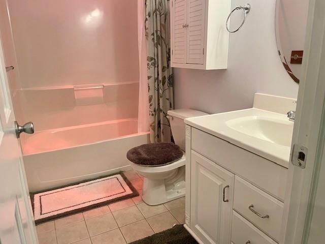 full bathroom featuring toilet, vanity, tile patterned flooring, and shower / tub combo