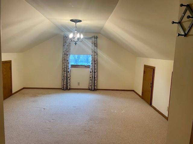 5475 Main St W, Maple Plain, MN 55359 - additional living space featuring light colored carpet, a chandelier, and vaulted ceiling
