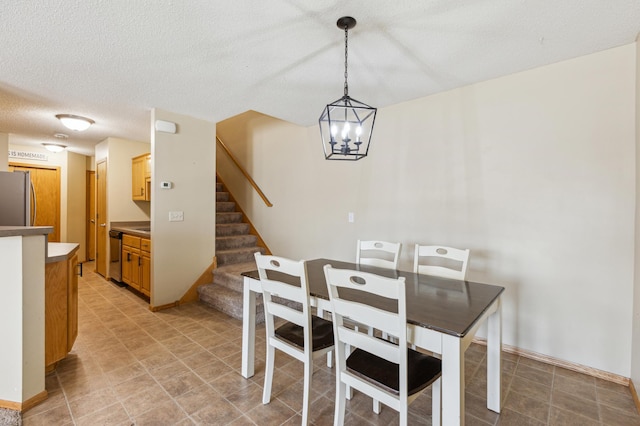 dining room with a textured ceiling, a chandelier, and stairway