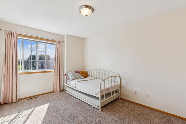 carpeted bedroom with baseboards and visible vents