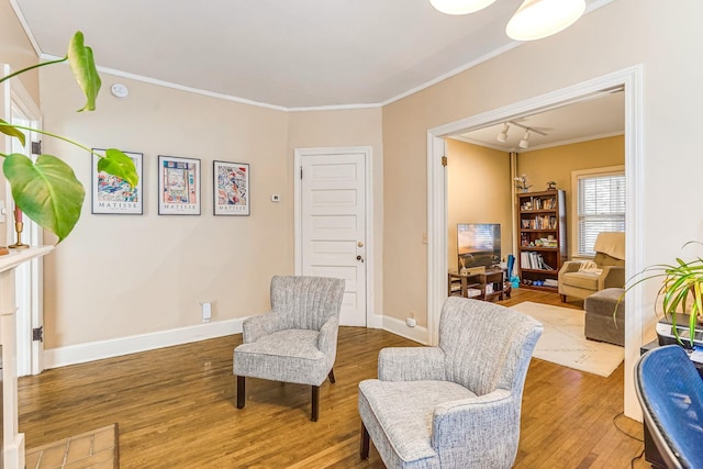 1976 Iglehart Ave, Saint Paul, MN 55104 - sitting room featuring wood finished floors, ornamental molding, baseboards, and track lighting