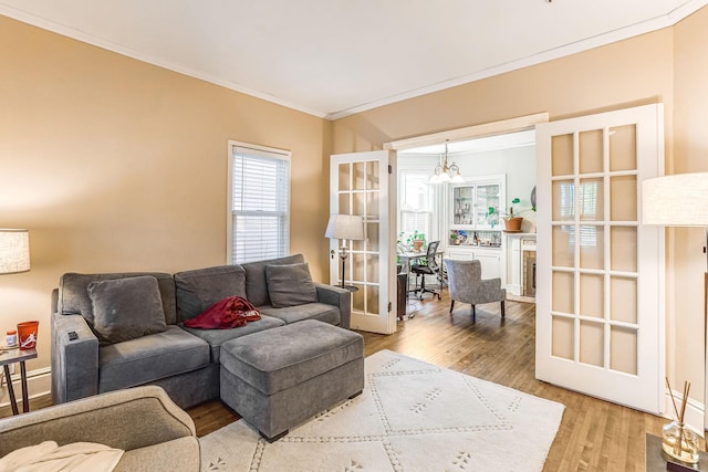 1976 Iglehart Ave, Saint Paul, MN 55104 - living room with ornamental molding, wood finished floors, and a chandelier