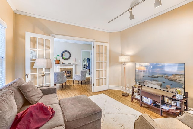 1976 Iglehart Ave, Saint Paul, MN 55104 - living area with crown molding, wood finished floors, a glass covered fireplace, baseboards, and french doors