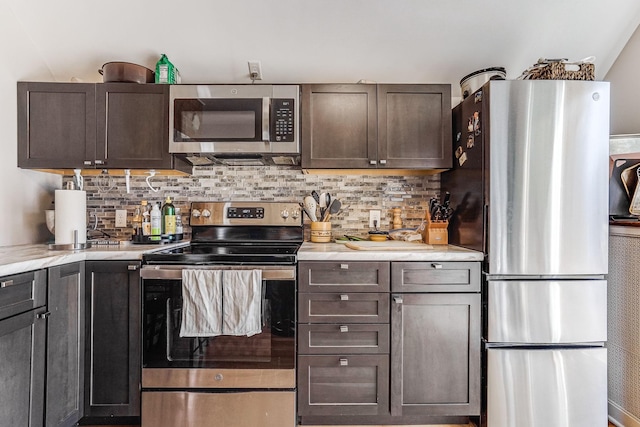 1976 Iglehart Ave, Saint Paul, MN 55104 - kitchen with appliances with stainless steel finishes, decorative backsplash, light countertops, and dark brown cabinetry