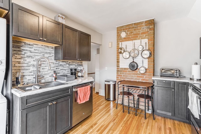 1976 Iglehart Ave, Saint Paul, MN 55104 - kitchen featuring stainless steel dishwasher, a sink, electric range oven, estacked washer and dryer, and light countertops