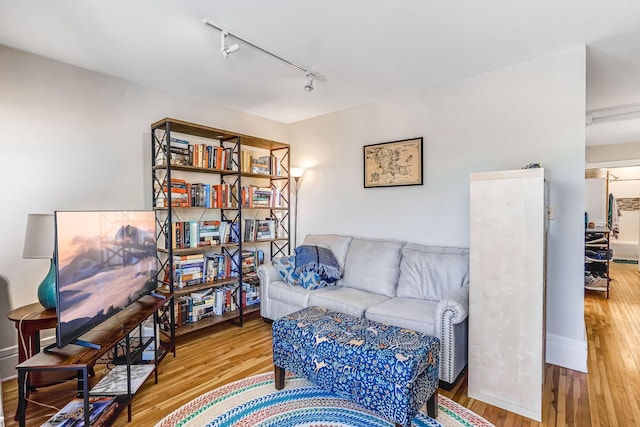 1976 Iglehart Ave, Saint Paul, MN 55104 - living area featuring track lighting, wood finished floors, and baseboards