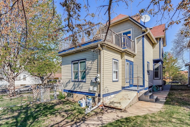 1976 Iglehart Ave, Saint Paul, MN 55104 - view of property exterior with a balcony and a chimney