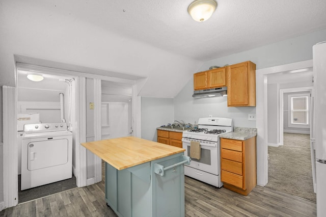 kitchen with washer / clothes dryer, under cabinet range hood, butcher block countertops, wood finished floors, and white gas stove