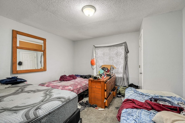 bedroom with a textured ceiling and carpet flooring