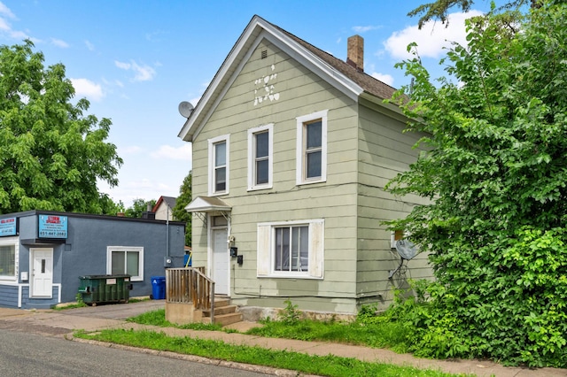 traditional home featuring a chimney