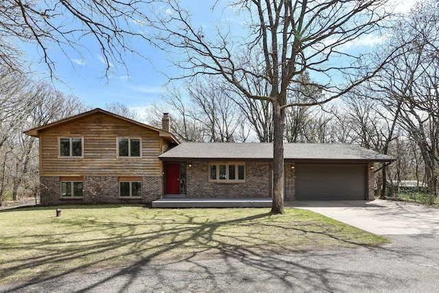 16881 169th Ave SE, Big Lake, MN 55309 - tri-level home featuring a front yard, a garage, brick siding, driveway, and a chimney