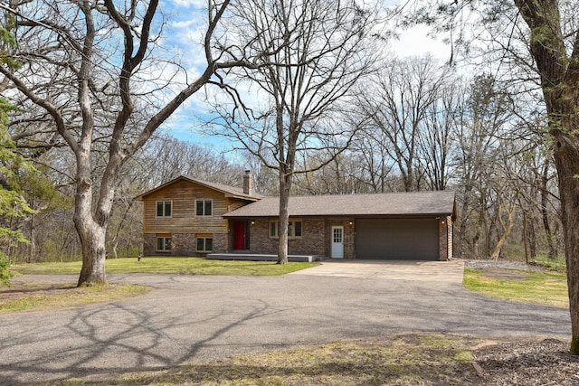 16881 169th Ave SE, Big Lake, MN 55309 - tri-level home with a front yard, driveway, a garage, and a chimney