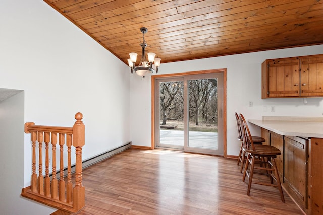 16881 169th Ave SE, Big Lake, MN 55309 - dining space with baseboard heating, baseboards, wooden ceiling, light wood finished floors, and a notable chandelier