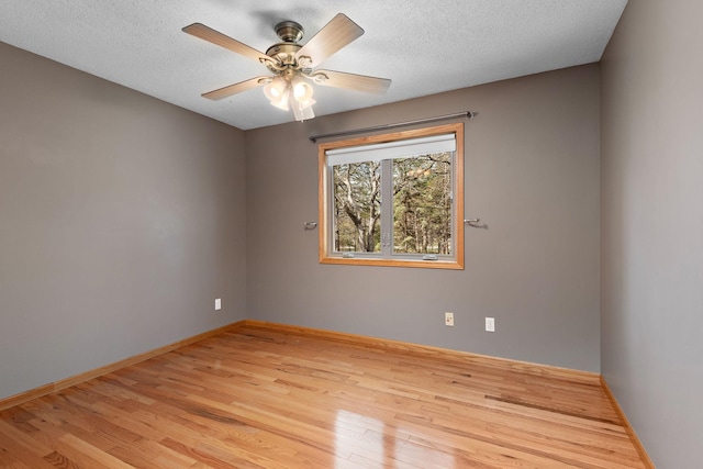 16881 169th Ave SE, Big Lake, MN 55309 - spare room with a ceiling fan, light wood-style flooring, a textured ceiling, and baseboards