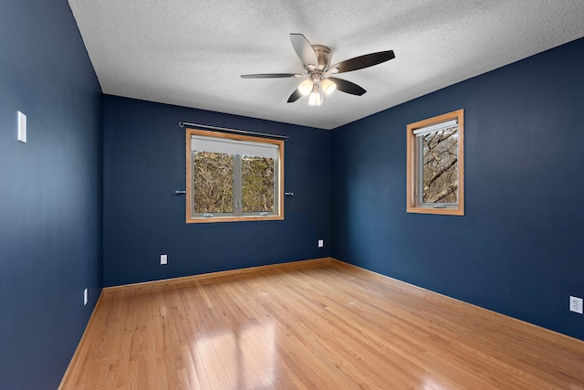 16881 169th Ave SE, Big Lake, MN 55309 - spare room with baseboards, wood finished floors, a ceiling fan, and a textured ceiling