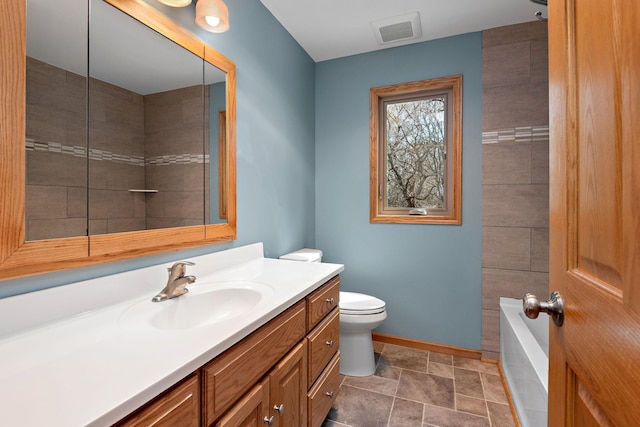 16881 169th Ave SE, Big Lake, MN 55309 - full bath with stone finish flooring, visible vents, baseboards, toilet, and vanity