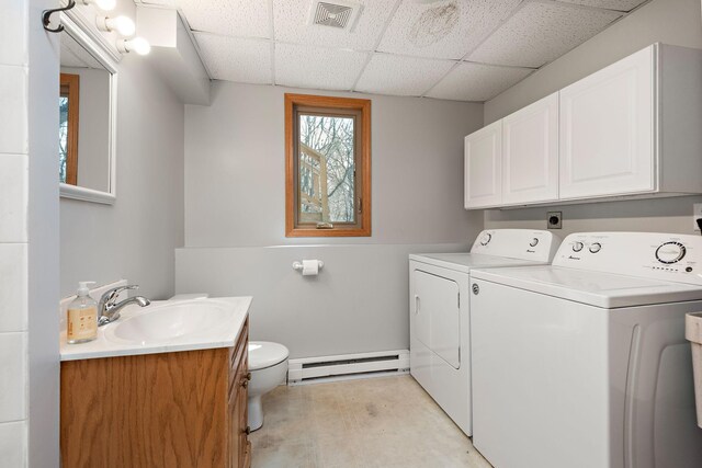 16881 169th Ave SE, Big Lake, MN 55309 - laundry room featuring washing machine and dryer, a sink, a baseboard radiator, visible vents, and laundry area