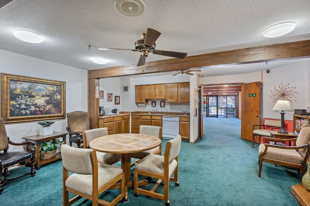 dining space featuring light colored carpet, ceiling fan, and a textured ceiling