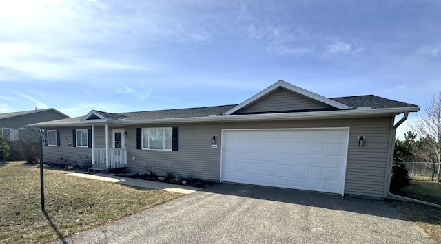 606 Tenth St W, Park Rapids, MN 56470 - ranch-style home with driveway, an attached garage, fence, and roof with shingles