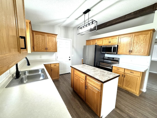 606 Tenth St W, Park Rapids, MN 56470 - kitchen featuring appliances with stainless steel finishes, a sink, a kitchen island, dark wood-type flooring, and light countertops