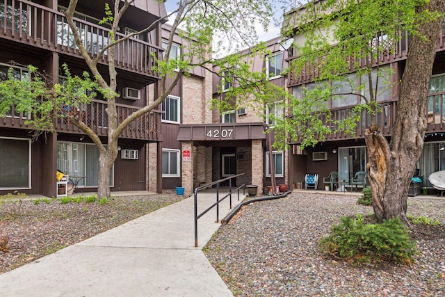 view of building exterior featuring a wall unit AC