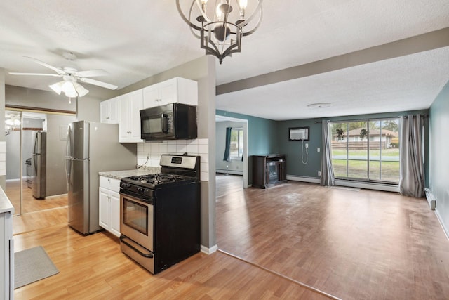 kitchen with white cabinets, stainless steel appliances, a wealth of natural light, and light countertops