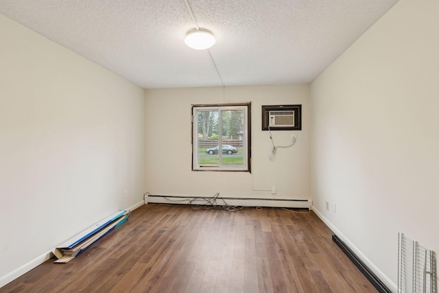 unfurnished room featuring baseboard heating, a baseboard heating unit, a wall mounted air conditioner, and wood finished floors