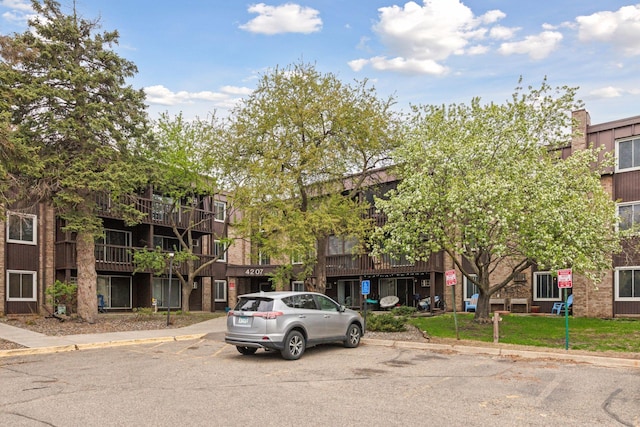 view of building exterior with uncovered parking