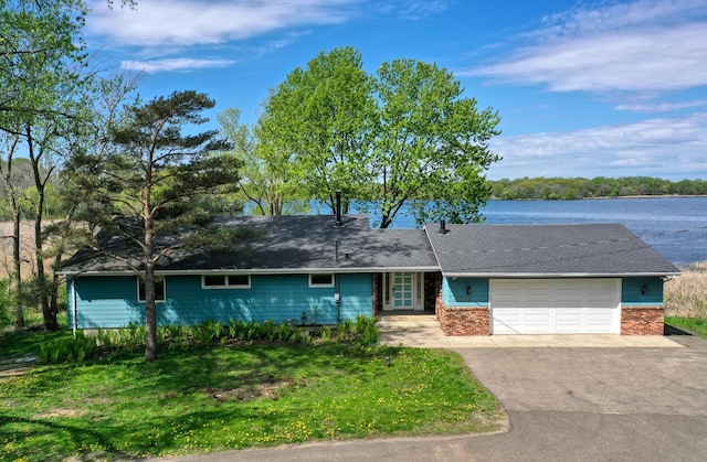12056 Everton Ave N, Hugo, MN 55110 - single story home with asphalt driveway, a garage, a front yard, and a water view