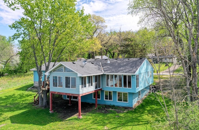 12056 Everton Ave N, Hugo, MN 55110 - rear view of property featuring roof with shingles, a yard, and a sunroom