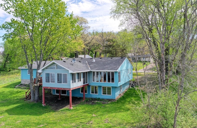12056 Everton Ave N, Hugo, MN 55110 - back of property with a lawn, roof with shingles, and a sunroom