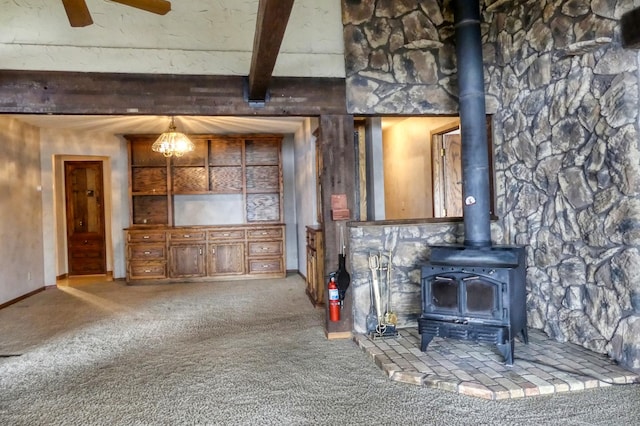 12056 Everton Ave N, Hugo, MN 55110 - living area with carpet floors, a wood stove, beamed ceiling, a ceiling fan, and baseboards