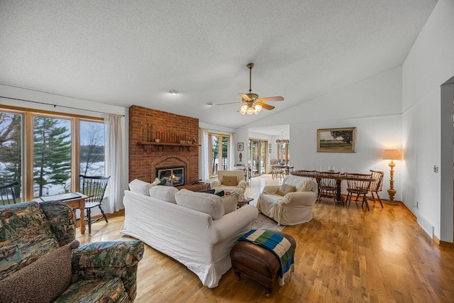 1171 County Rd E, Scott Twp, WI 54801 - living area with ceiling fan, vaulted ceiling, a wealth of natural light, and a fireplace