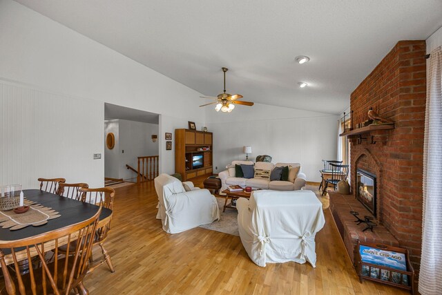 1171 County Rd E, Scott Twp, WI 54801 - living room with light wood-style floors, a ceiling fan, a fireplace, and vaulted ceiling
