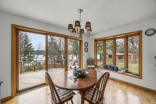 1171 County Rd E, Scott Twp, WI 54801 - dining area with plenty of natural light, light wood-type flooring, a textured ceiling, and a notable chandelier
