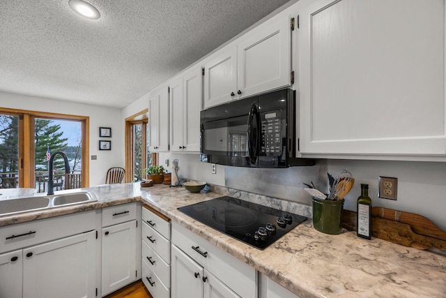 1171 County Rd E, Scott Twp, WI 54801 - kitchen with a sink, a textured ceiling, black appliances, and white cabinets