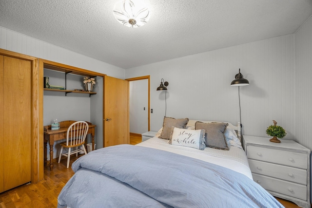 1171 County Rd E, Scott Twp, WI 54801 - bedroom featuring a textured ceiling, wood finished floors, and a closet