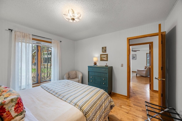1171 County Rd E, Scott Twp, WI 54801 - bedroom with a textured ceiling, baseboards, and light wood-style flooring